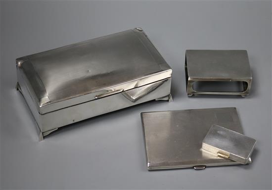 An engine turned silver cigarette case, a silver pill box, a silver matchbox sleeve and silver cigarette box (a.f.).